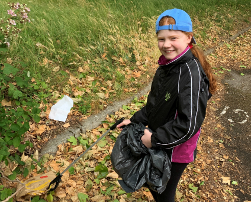 Daisy helps to clear up litter